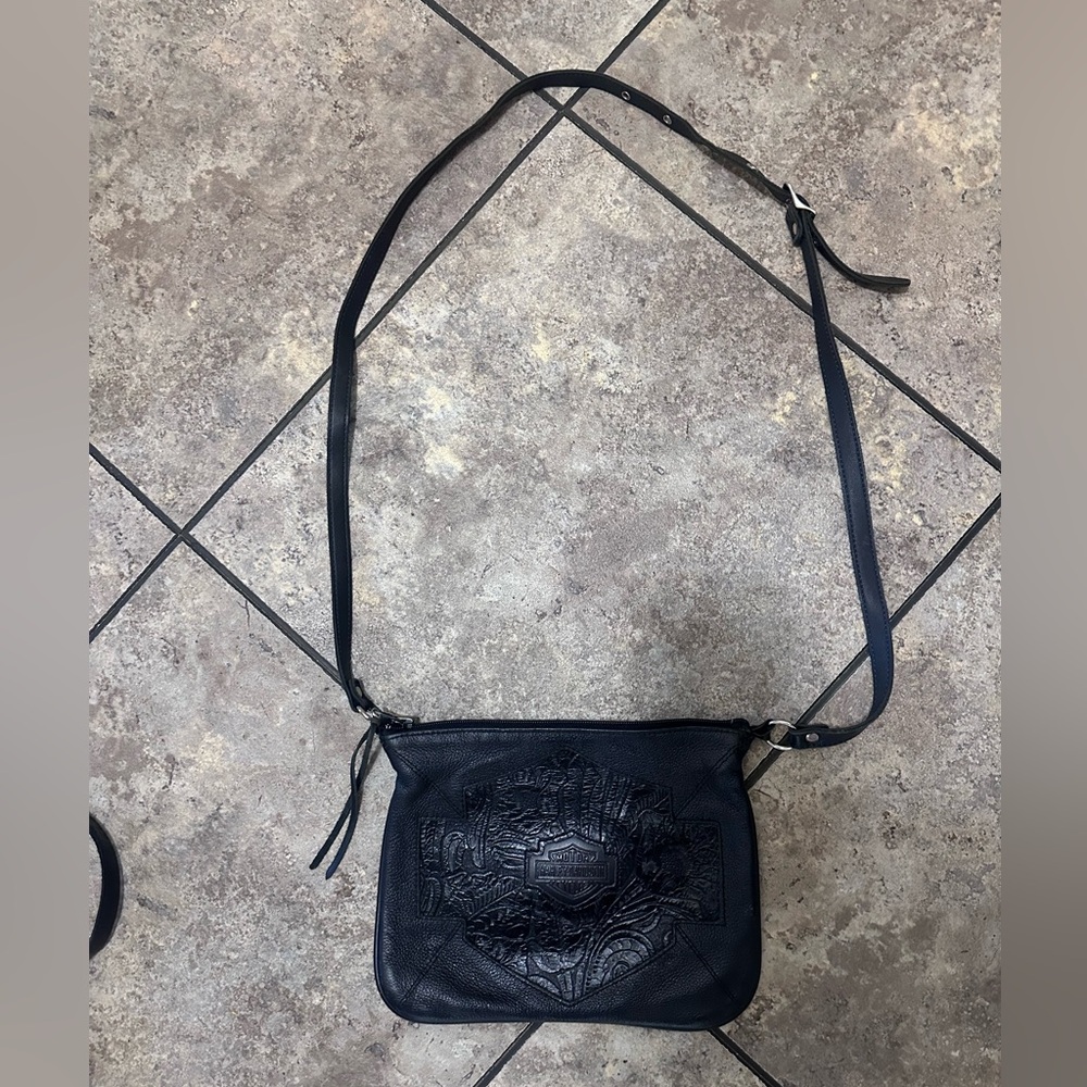 Harley-Davidson Black Embossed Leather Crossbody Bag with adjustable straps.